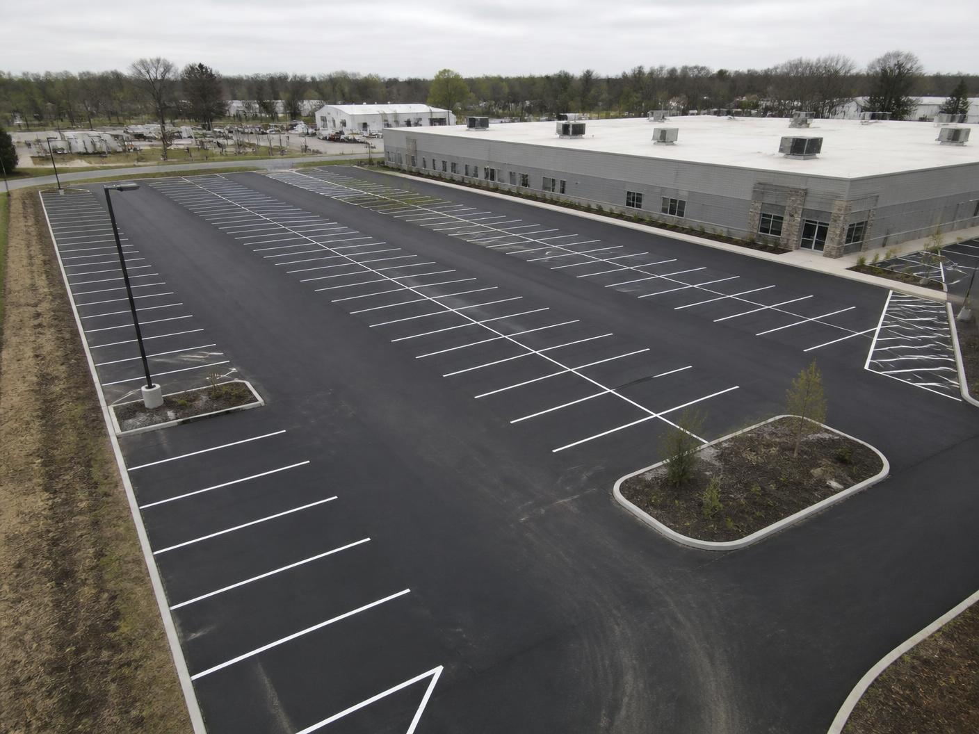Aerial view of a newly paved and striped commercial parking lot