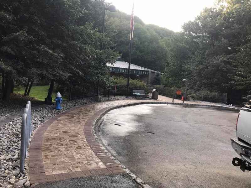 Freshly paved asphalt entrance drive with a paver border at a New Jersey property