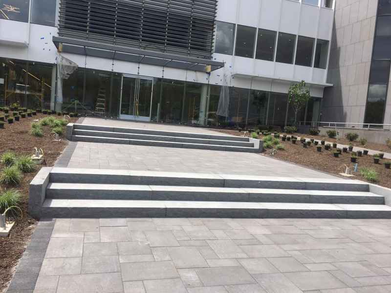 Paver entrance plaza with wide steps at a commercial office building in New Jersey