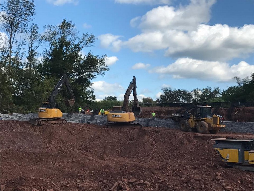 Excavators moving soil during mass grading on a New Jersey construction site
